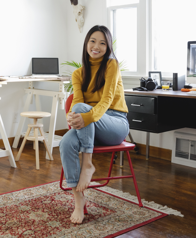 male assurant employee sitting and smiling at camera